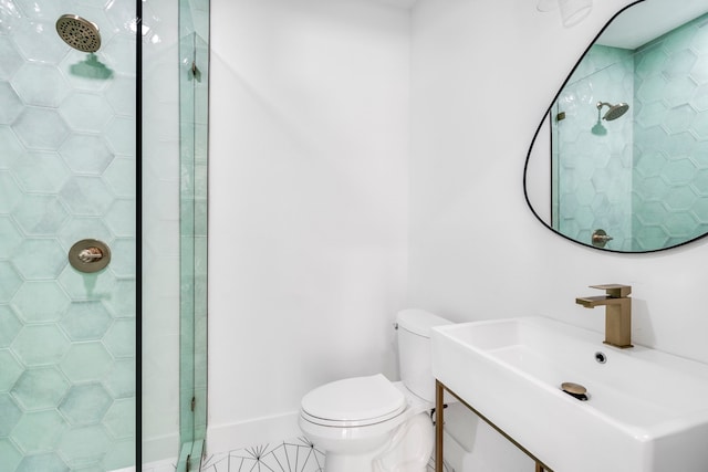 full bathroom featuring toilet, a shower stall, vanity, tile patterned flooring, and baseboards