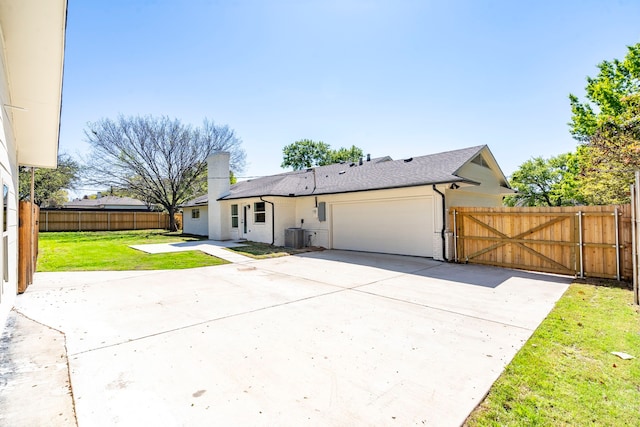 view of front of home featuring a gate, fence, a front lawn, and concrete driveway