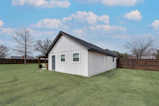 view of outdoor structure with a garage and a fenced backyard