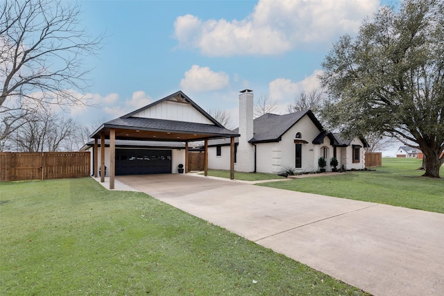 view of front of home featuring brick siding, fence, concrete driveway, a chimney, and a front yard