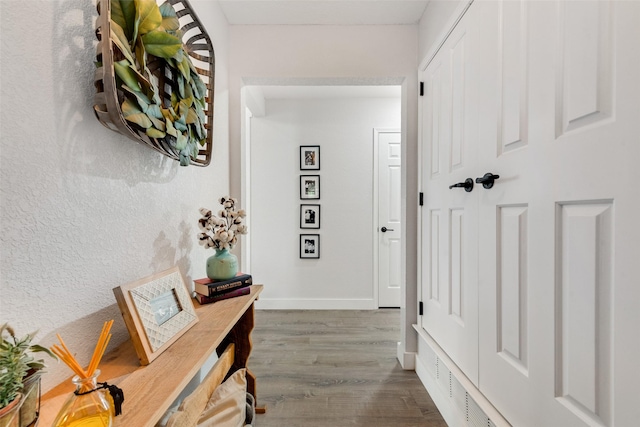 interior space featuring baseboards and wood finished floors