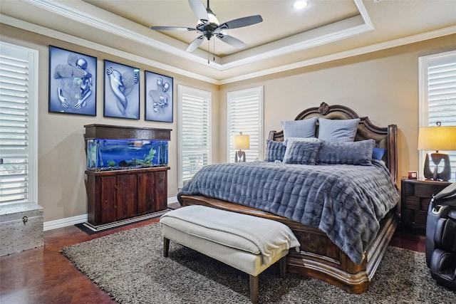 bedroom featuring ornamental molding, a raised ceiling, multiple windows, and baseboards