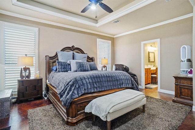 bedroom featuring ornamental molding, multiple windows, a raised ceiling, and visible vents