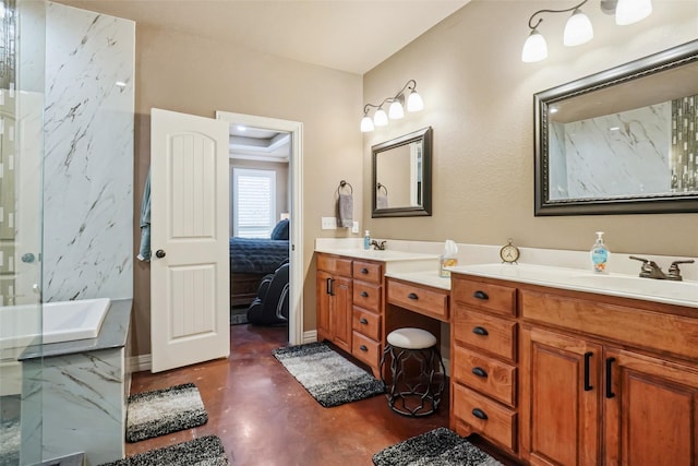 full bath with concrete flooring, a sink, baseboards, double vanity, and ensuite bath