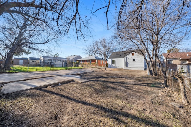 view of yard featuring a residential view and fence