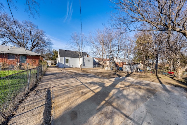 view of front facade with a residential view and fence