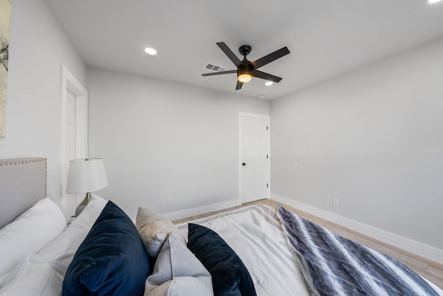 bedroom featuring light wood-type flooring, visible vents, baseboards, and recessed lighting