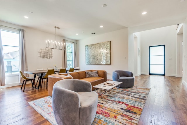 living area with plenty of natural light, wood finished floors, and recessed lighting