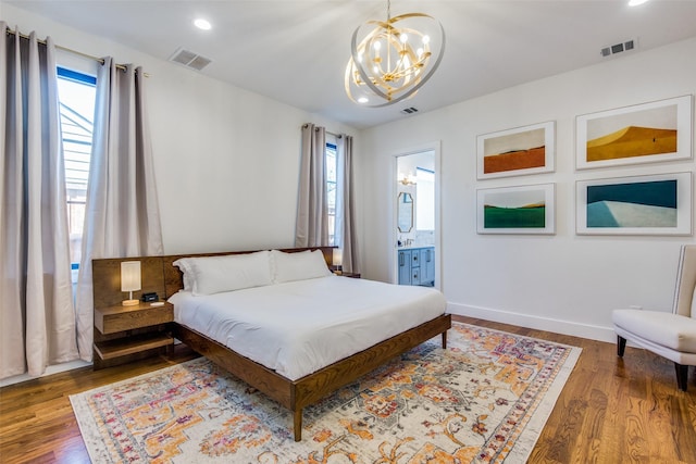 bedroom with visible vents, multiple windows, and wood finished floors