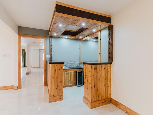 bar with baseboards, wine cooler, indoor wet bar, and recessed lighting