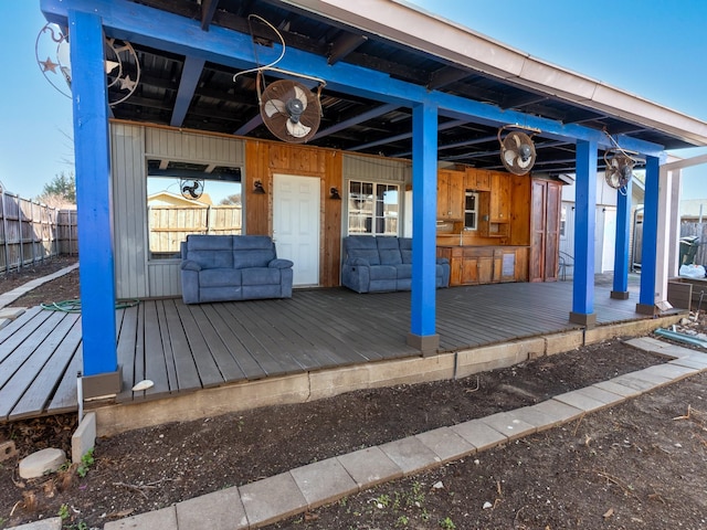 wooden terrace featuring fence