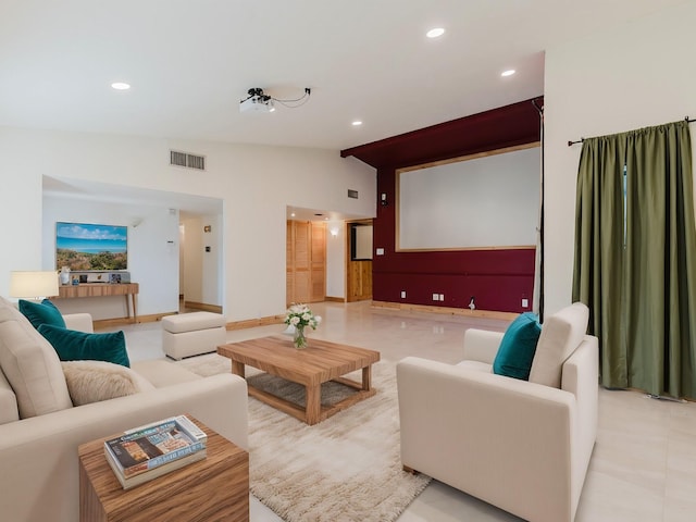 cinema room with lofted ceiling, visible vents, and recessed lighting