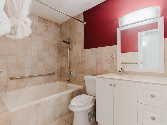 full bath featuring toilet, tile patterned flooring, tiled shower / bath, vanity, and tile walls