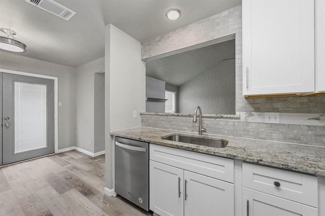 kitchen with visible vents, light wood-style flooring, white cabinets, a sink, and dishwasher