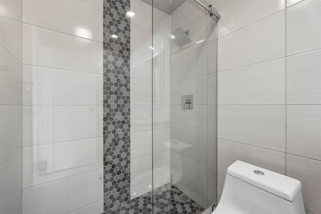 full bath with a stall shower and toilet