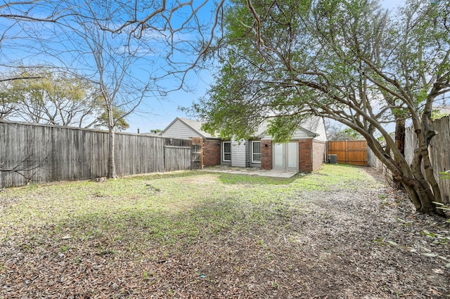 view of yard featuring an outbuilding and a fenced backyard