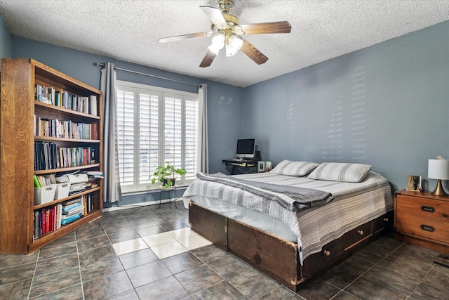 bedroom featuring ceiling fan, a textured ceiling, and tile patterned floors