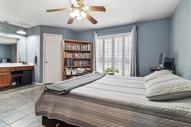 bedroom with a ceiling fan, a textured ceiling, and light tile patterned floors