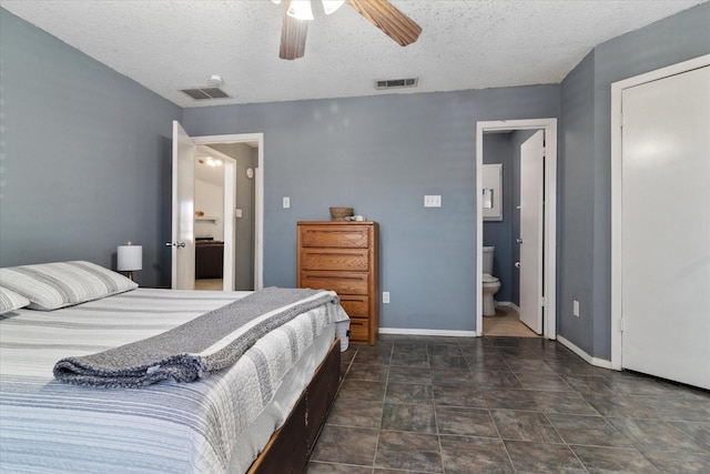 bedroom featuring a textured ceiling, connected bathroom, visible vents, and baseboards