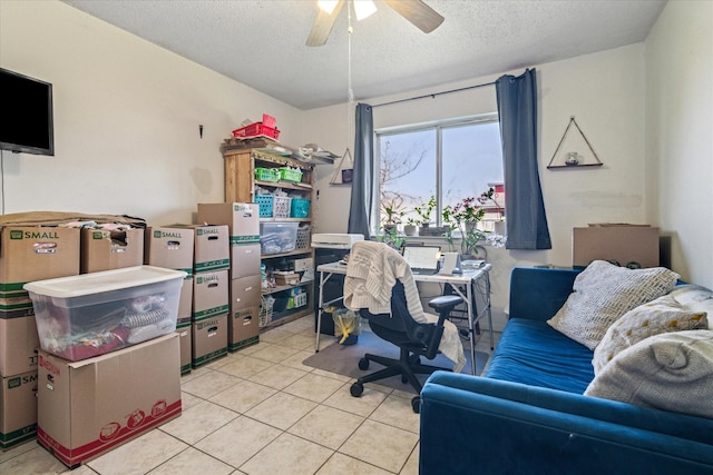 office space with ceiling fan, a textured ceiling, and light tile patterned floors