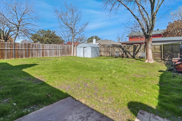 view of yard with a storage shed, a fenced backyard, and an outdoor structure