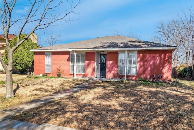 ranch-style home featuring brick siding