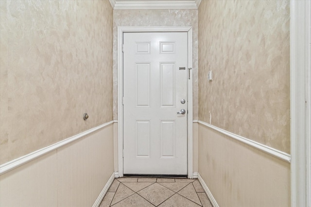 doorway to outside featuring light tile patterned floors and ornamental molding