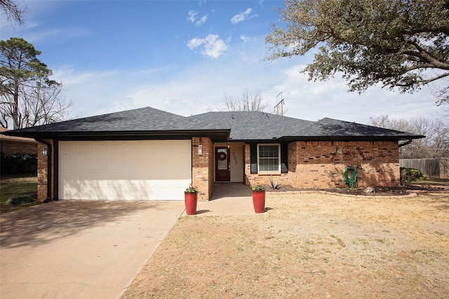 single story home featuring a garage, driveway, brick siding, and roof with shingles