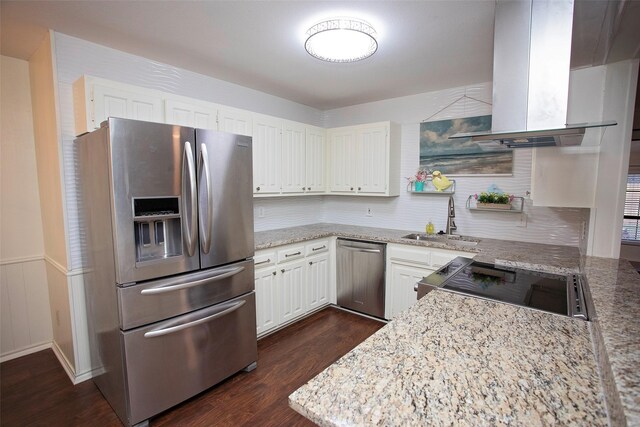 kitchen with white cabinets, dark wood-style flooring, extractor fan, stainless steel appliances, and a sink