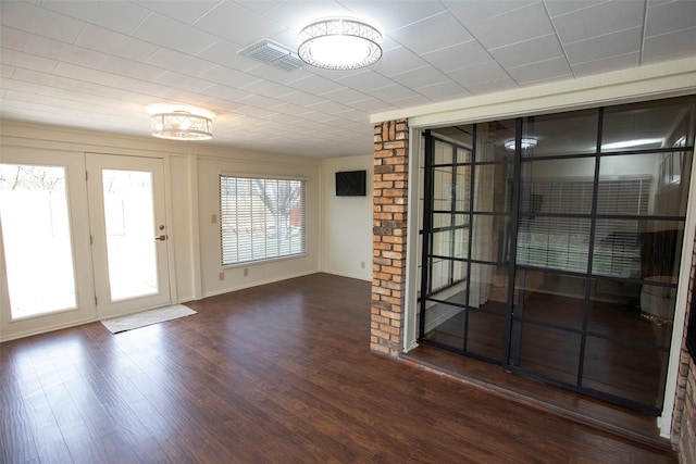 doorway to outside featuring visible vents and wood finished floors