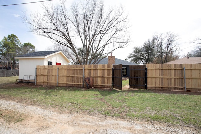 view of yard with fence and a gate