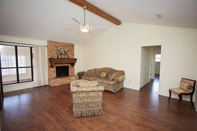 living area with dark wood-style floors, a fireplace, visible vents, and vaulted ceiling with beams