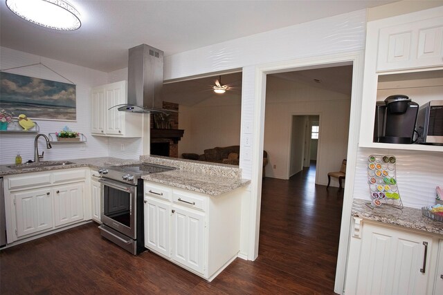 kitchen with stainless steel range, dark wood finished floors, a sink, and exhaust hood