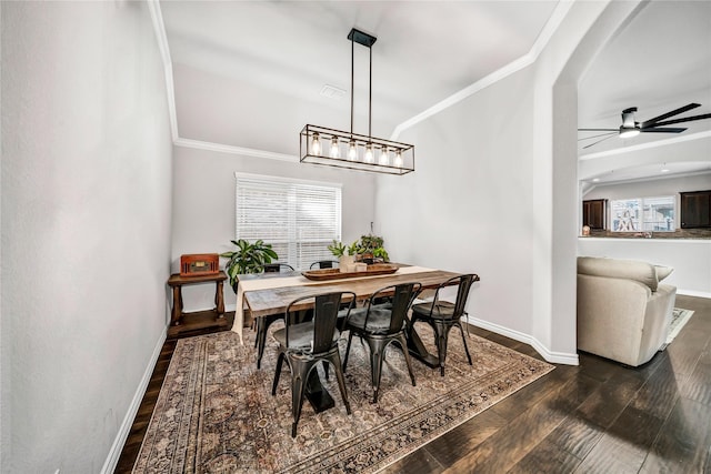 dining space with a healthy amount of sunlight, baseboards, dark wood finished floors, and crown molding