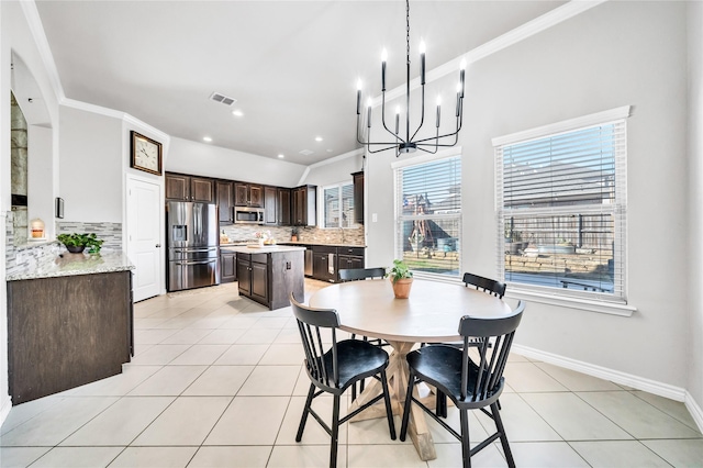 dining room with crown molding, recessed lighting, an inviting chandelier, light tile patterned flooring, and baseboards