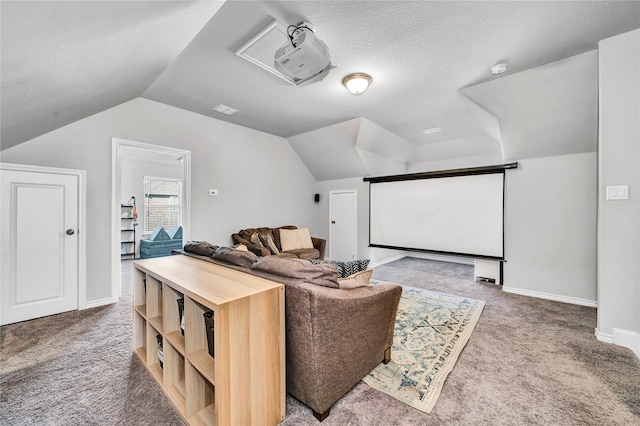 carpeted home theater with lofted ceiling, a textured ceiling, visible vents, and baseboards