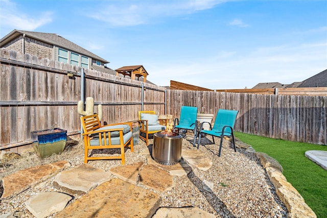 view of patio with a fire pit and a fenced backyard