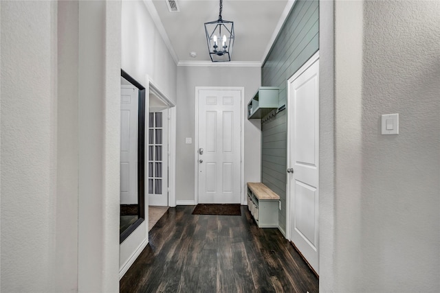 mudroom featuring baseboards, visible vents, dark wood-type flooring, crown molding, and a chandelier