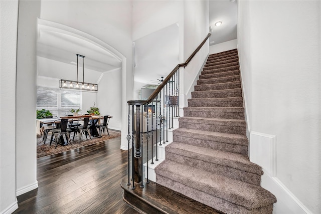 staircase with wood-type flooring and baseboards