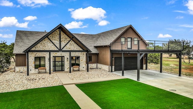 view of front of home with stone siding, driveway, roof with shingles, a front lawn, and board and batten siding