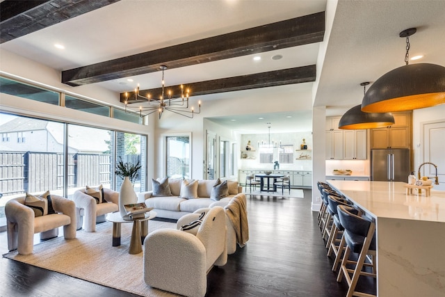 living room featuring an inviting chandelier, recessed lighting, dark wood-type flooring, and beamed ceiling