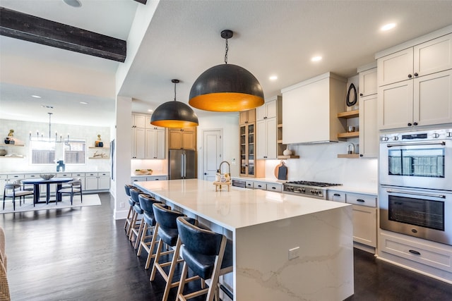 kitchen with tasteful backsplash, a spacious island, appliances with stainless steel finishes, dark wood-style flooring, and open shelves