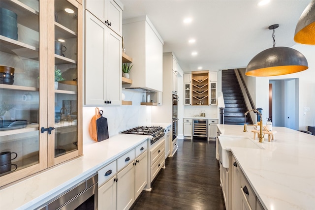 kitchen with beverage cooler, stainless steel appliances, open shelves, dark wood finished floors, and decorative light fixtures