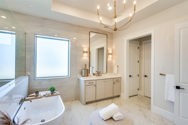 bathroom with marble finish floor, a freestanding tub, vanity, and walk in shower