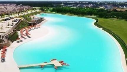 view of pool with a water view