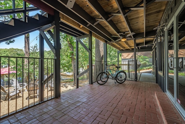 unfurnished sunroom with plenty of natural light and ceiling fan