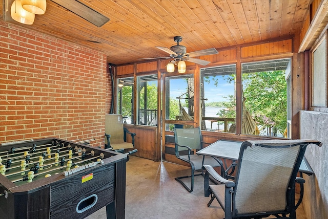 sunroom / solarium featuring wooden ceiling and ceiling fan