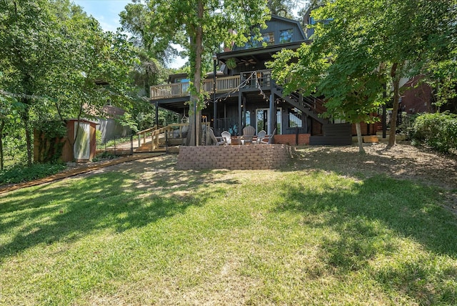 view of yard featuring a deck, an outbuilding, and stairway