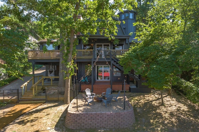 back of property featuring a patio, an outdoor fire pit, stairway, and a wooden deck