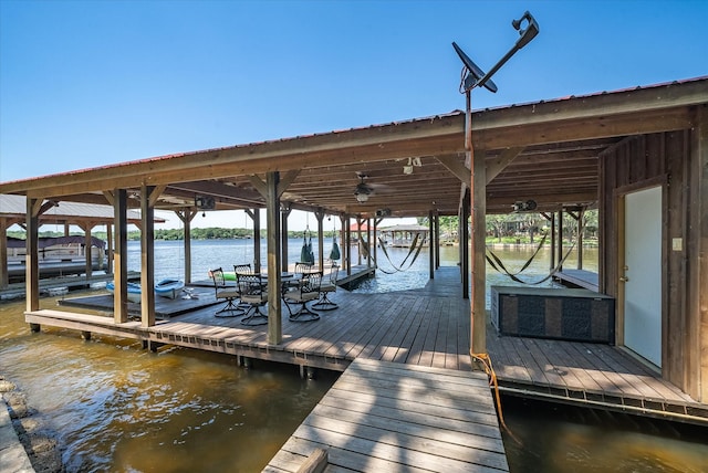 dock area with a water view and boat lift